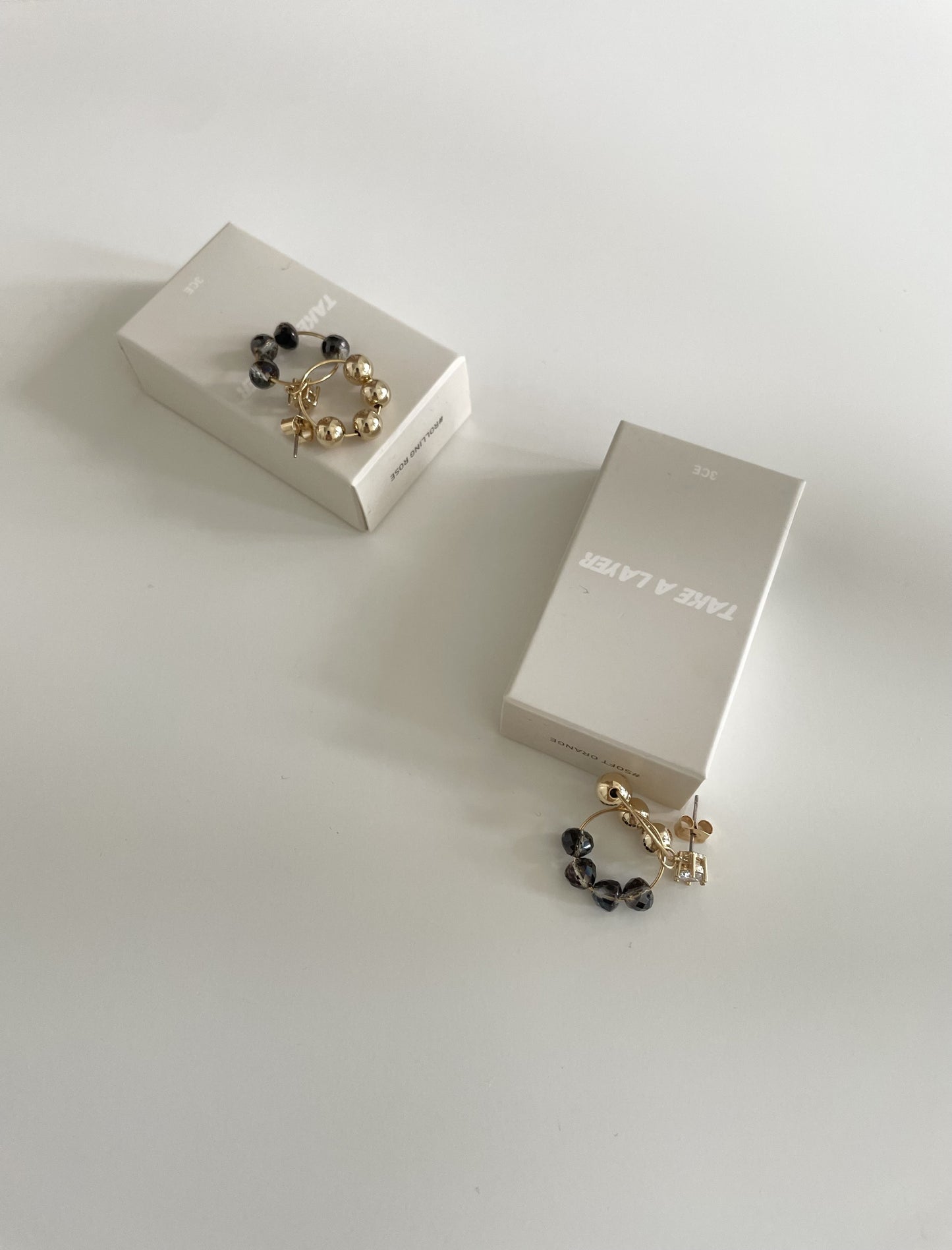 Black and gold hoop diamond earrings