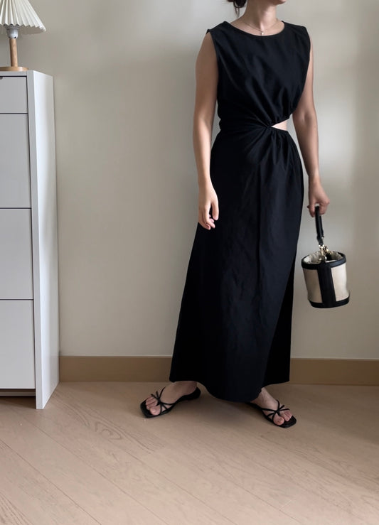 Sleeveless black maxi dress with cutouts at the waist